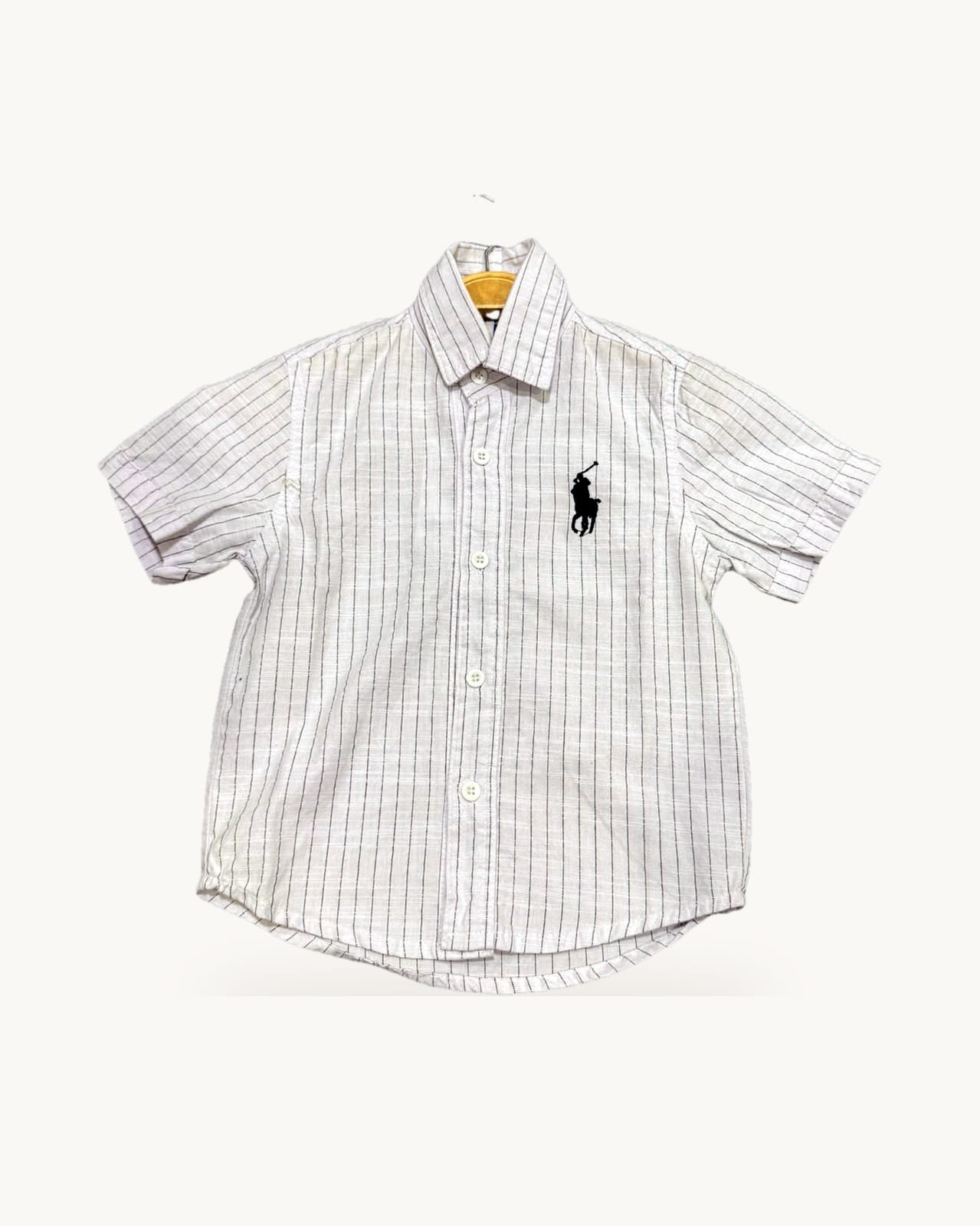 White and pink striped shirt on a hanger